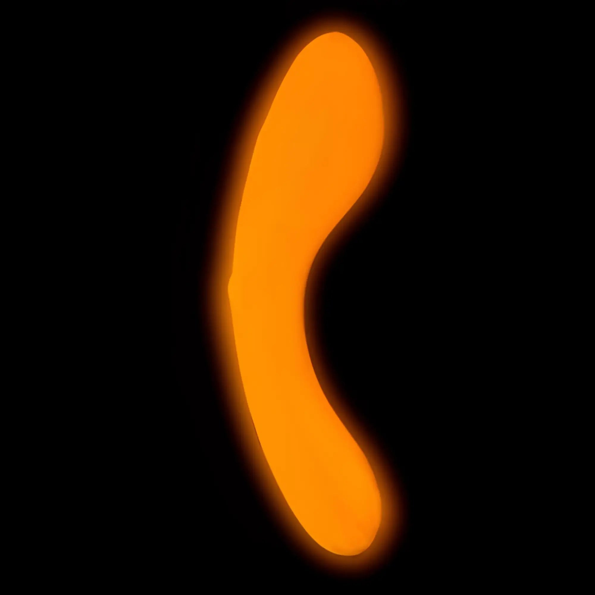 A glowing orange mini swan wand with a smooth curved translucent surface for personal use