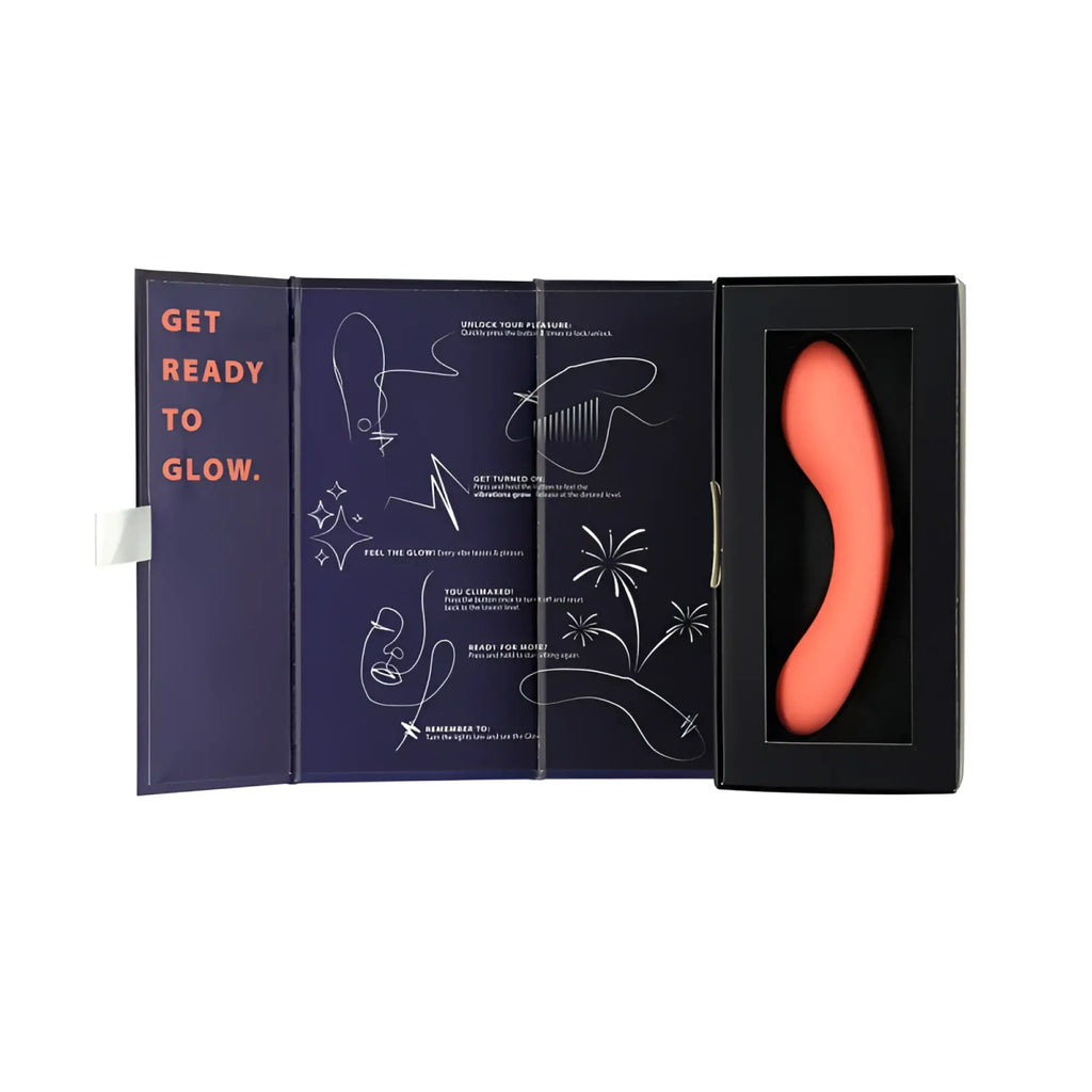 A sleek coral silicone pleasure device swan the mini swan wand glow orange in a black box with instructional diagrams
