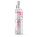 A clear plastic spray bottle with silver nozzle and pink floral design labeled desire by swiss navy toy and body cleaner