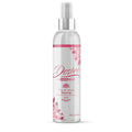 A clear plastic spray bottle with silver nozzle and pink floral design labeled desire by swiss navy toy and body cleaner