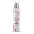 A clear plastic bottle with silver pump labeled desire by Swiss Navy water based intimate lubricant 4oz with floral design