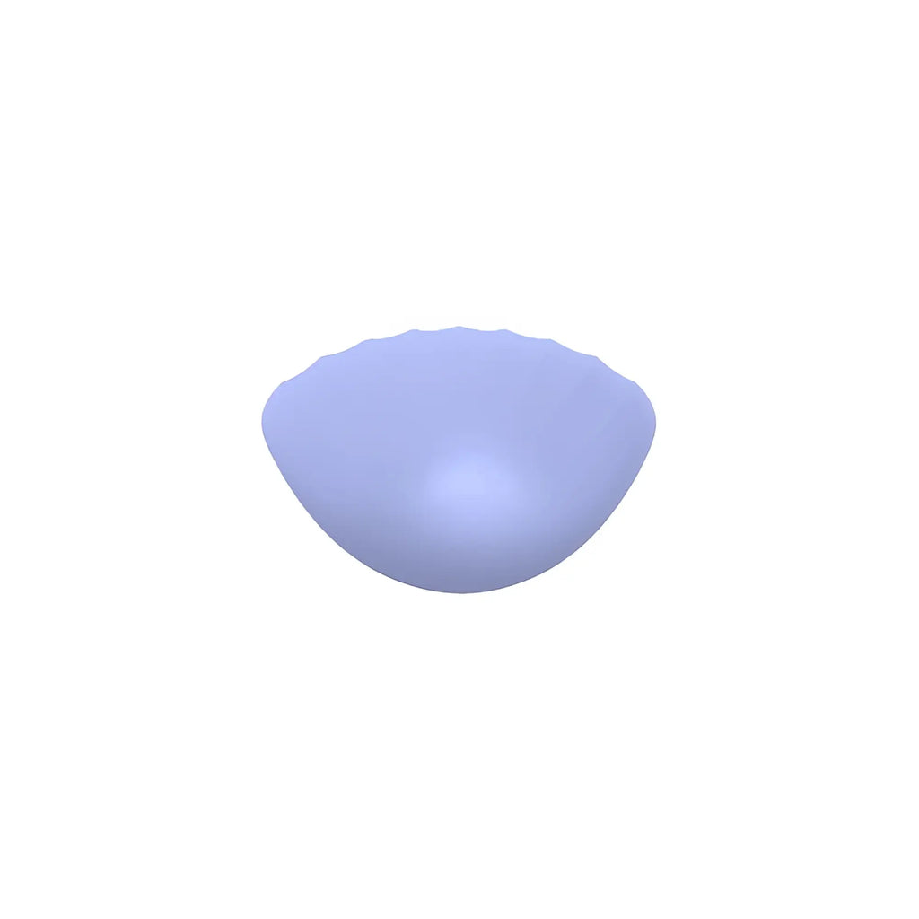 A soft lavender semi-translucent silicone breast form with a gently curved shell shape in the sxe destiny vibrating massager