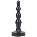 Black silicone anal plug with segmented rounded design and wide base tantus ripple small onyx front view