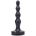 Black silicone anal plug with segmented rounded design and wide base tantus ripple small onyx front view