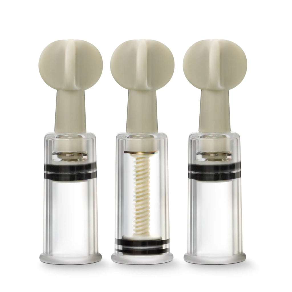Three beige-topped transparent glass temptasia nipple and clit twist suckers with black bands and spiral mechanisms