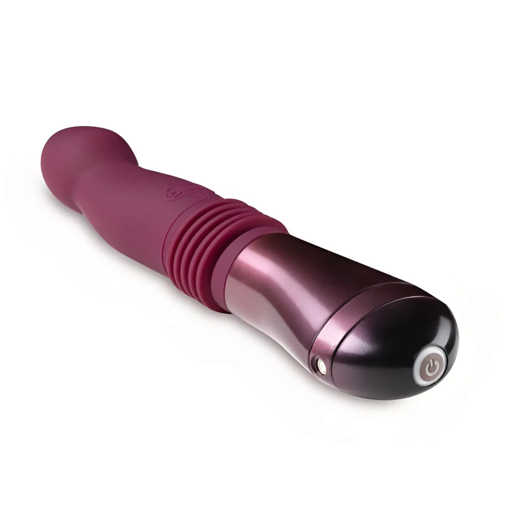 A sleek plum-colored Temptasia Trixie thrusting dildo with a glossy metallic finish and textured grip sections