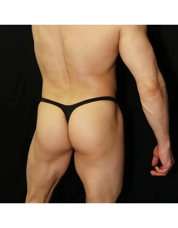 Black eco-leather thong underwear shown on a model featuring a minimal design by Arroyman.