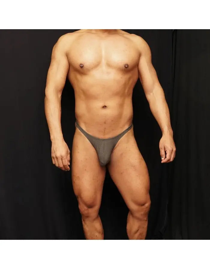 Moss green spandex thong by Arroyman featuring a sleek design and minimal coverage worn by a model.