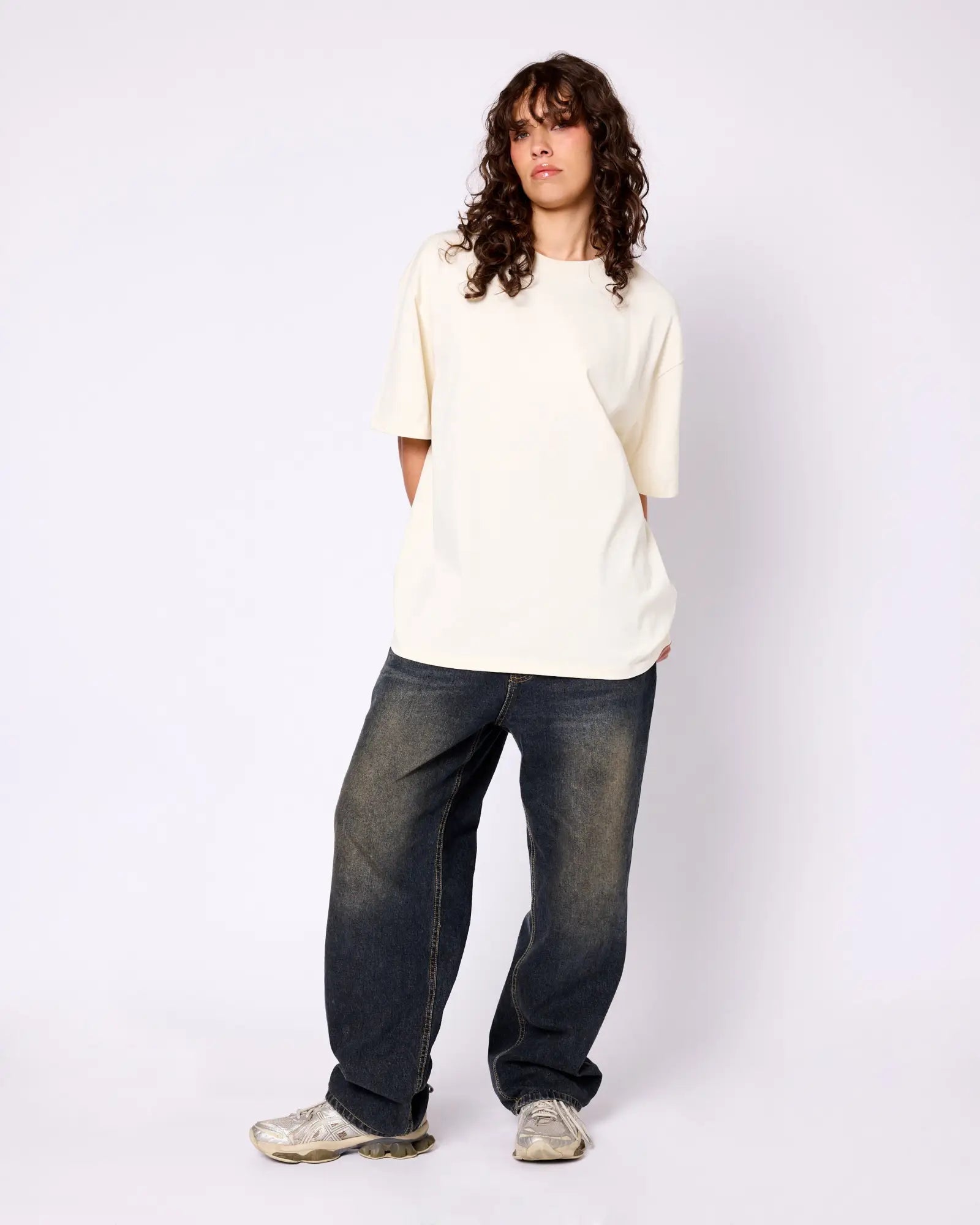 Model wearing a premium, oversized cream-colored crewneck t-shirt with short sleeves against a plain white background.