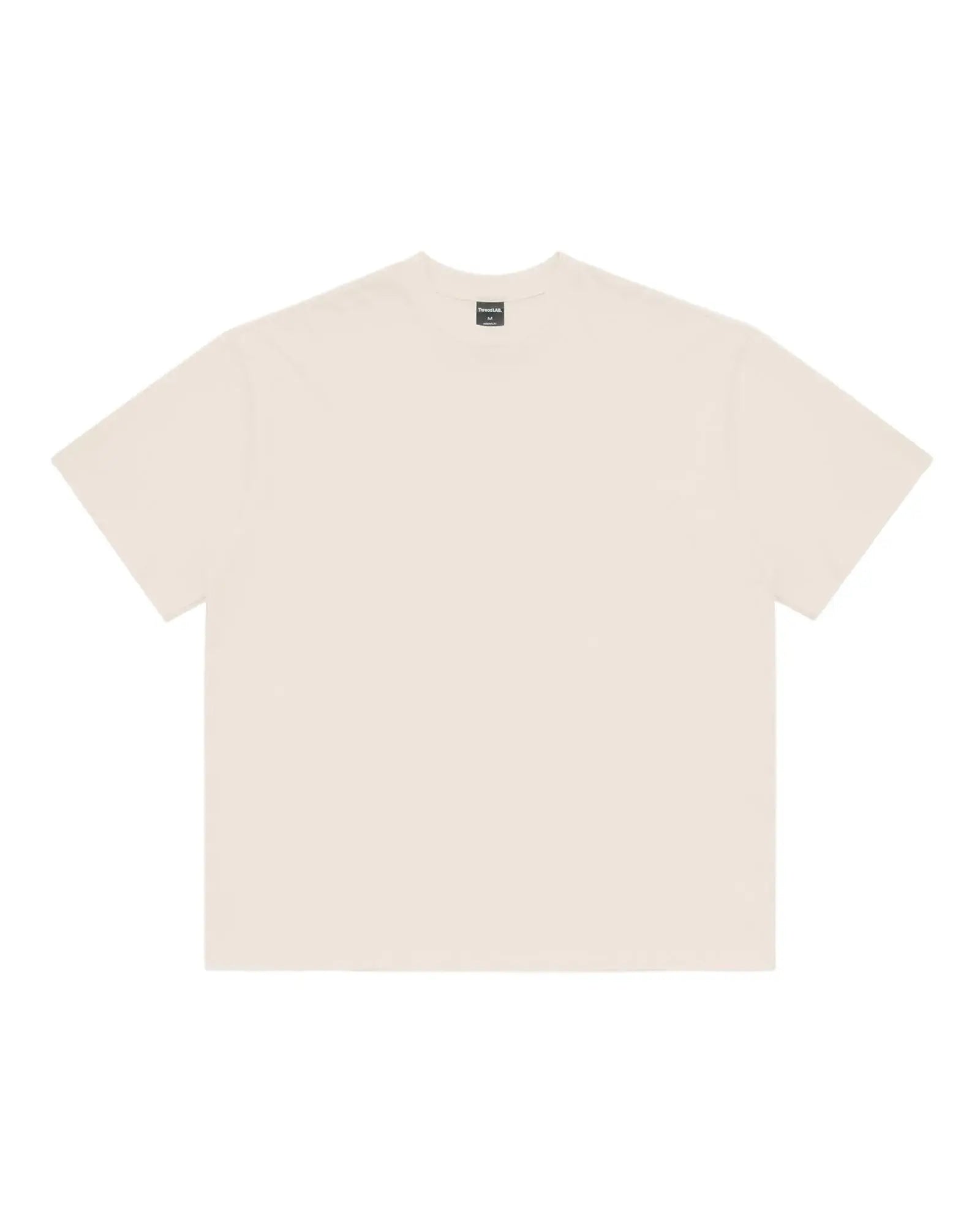 Cream-colored premium crew-neck t-shirt with a relaxed, boxy fit and a black interior brand label at the neckline.