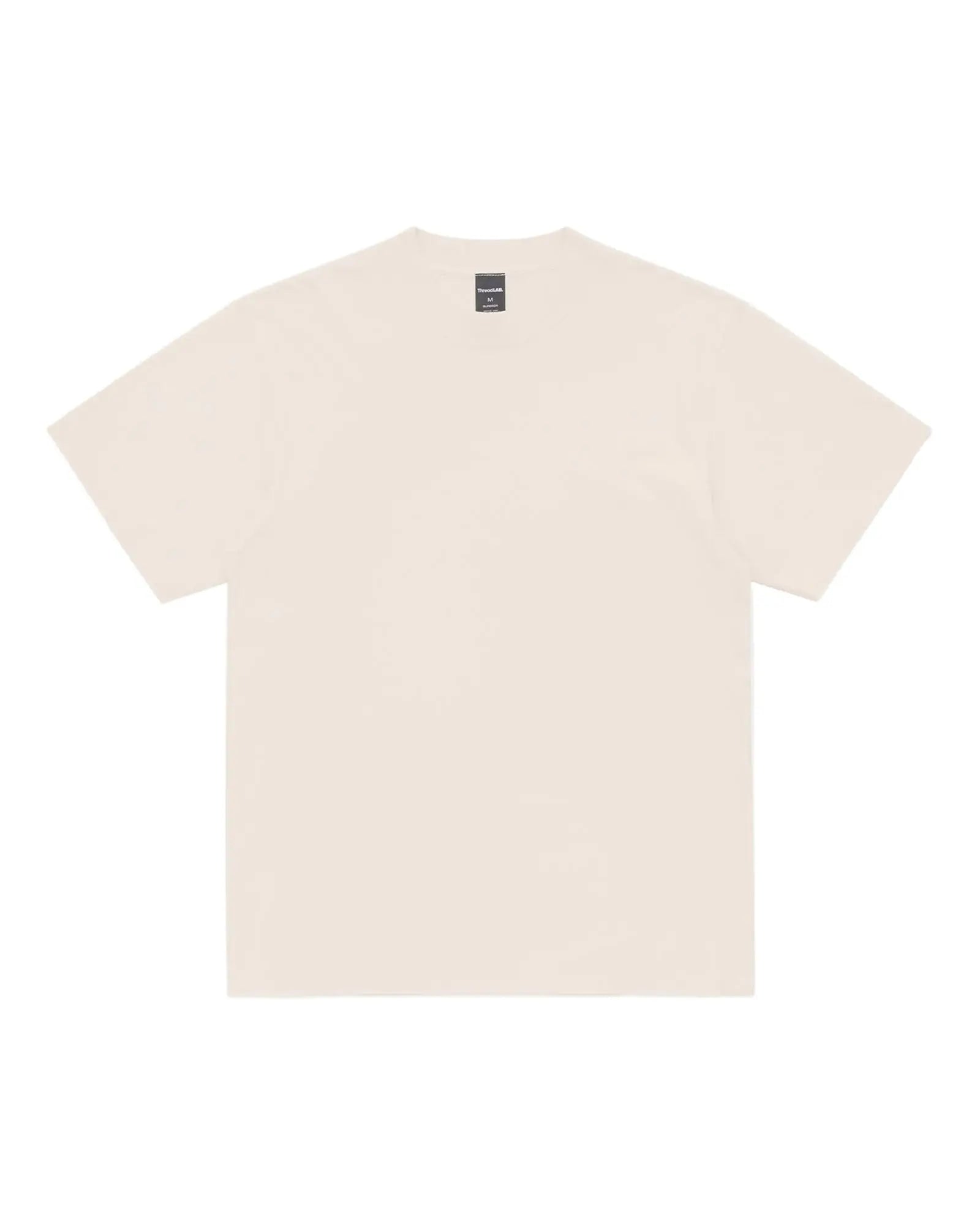 A plain cream-colored short-sleeve Superior Tee with a crew neck and a visible brand tag on the inner collar.