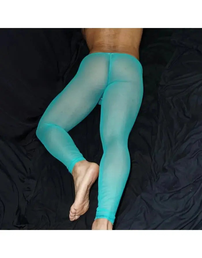 Men's green tulle gym tights by Arroyman featuring a sheer design and a snug fit shown on a model lying on a dark surface.