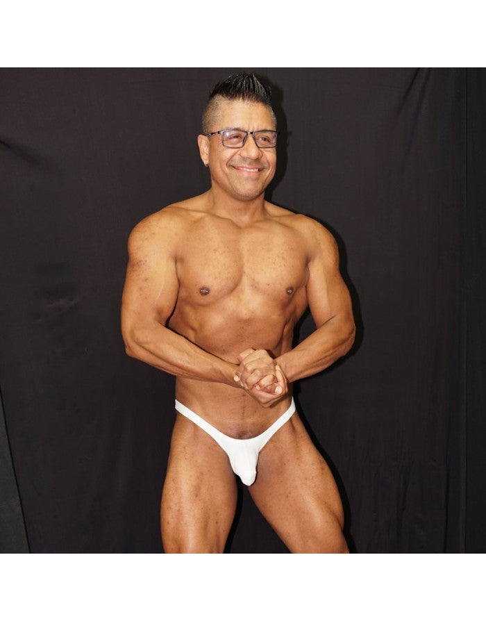 White micro bulge bikini underwear by Arroyman featuring a snug fit and minimal coverage modeled by a man.