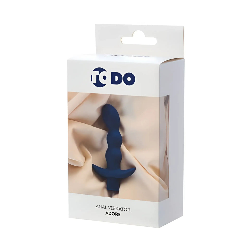 Dark blue silicone anal vibrator adore by to do shown inside its white packaging for intimate use