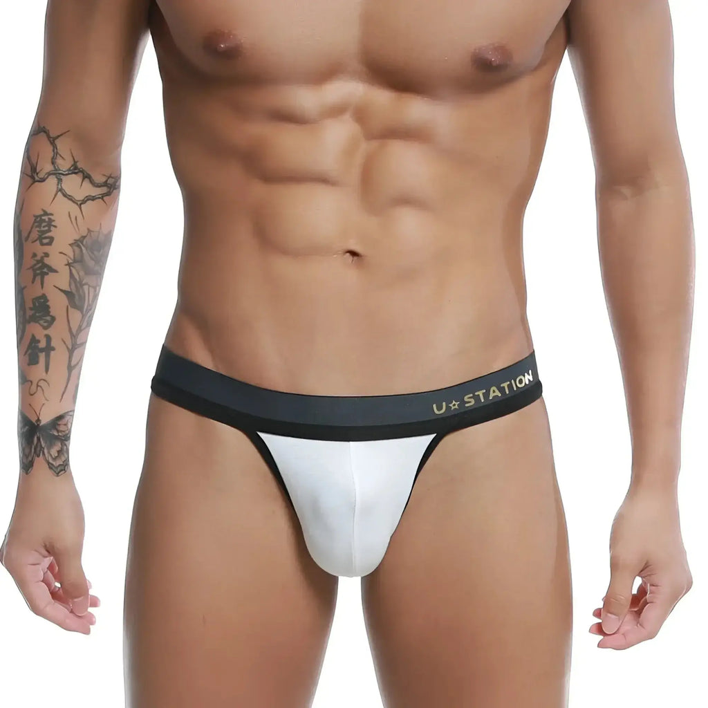 White ustation talent thong featuring a black waistband made of soft fabric for comfortable wear