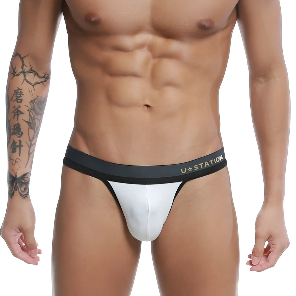 White ustation talent thong featuring a black waistband made of soft fabric for comfortable wear