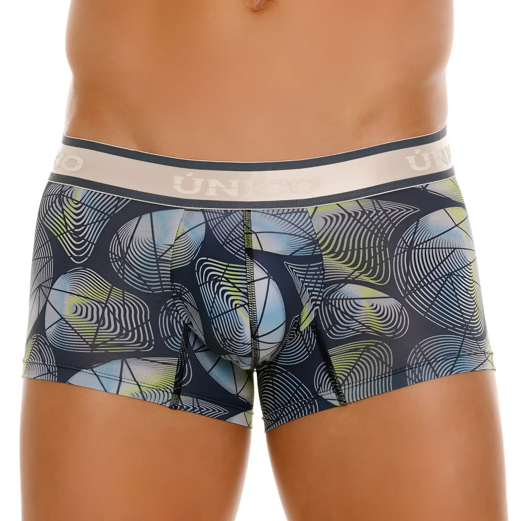 Dark blue unico resplandecer trunks with vibrant abstract swirling shapes in light blue white lime green and beige waistband