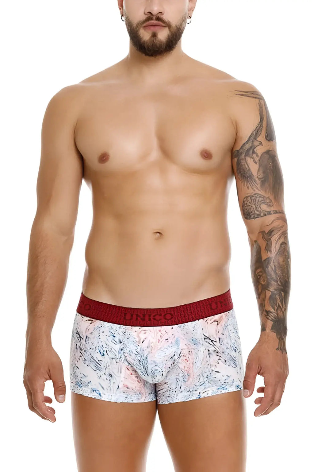 White boxer briefs with pink and blue abstract pattern and red elastic waistband featuring unico logo