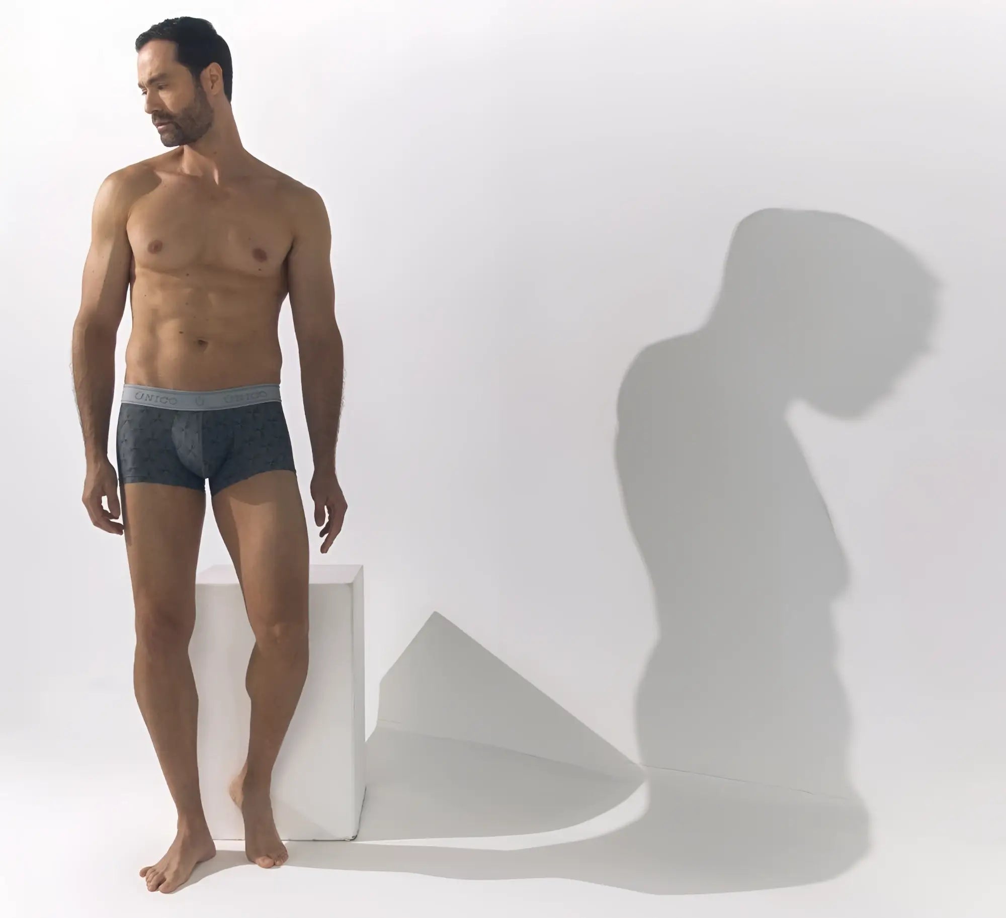 Dark gray calvin klein chisell trunks with light gray waistband featuring logo in comfortable cotton blend fabric