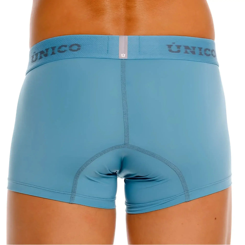Light blue unico 26020100118 ventisca trunks with matching elastic waistband featuring dark gray unico lettering