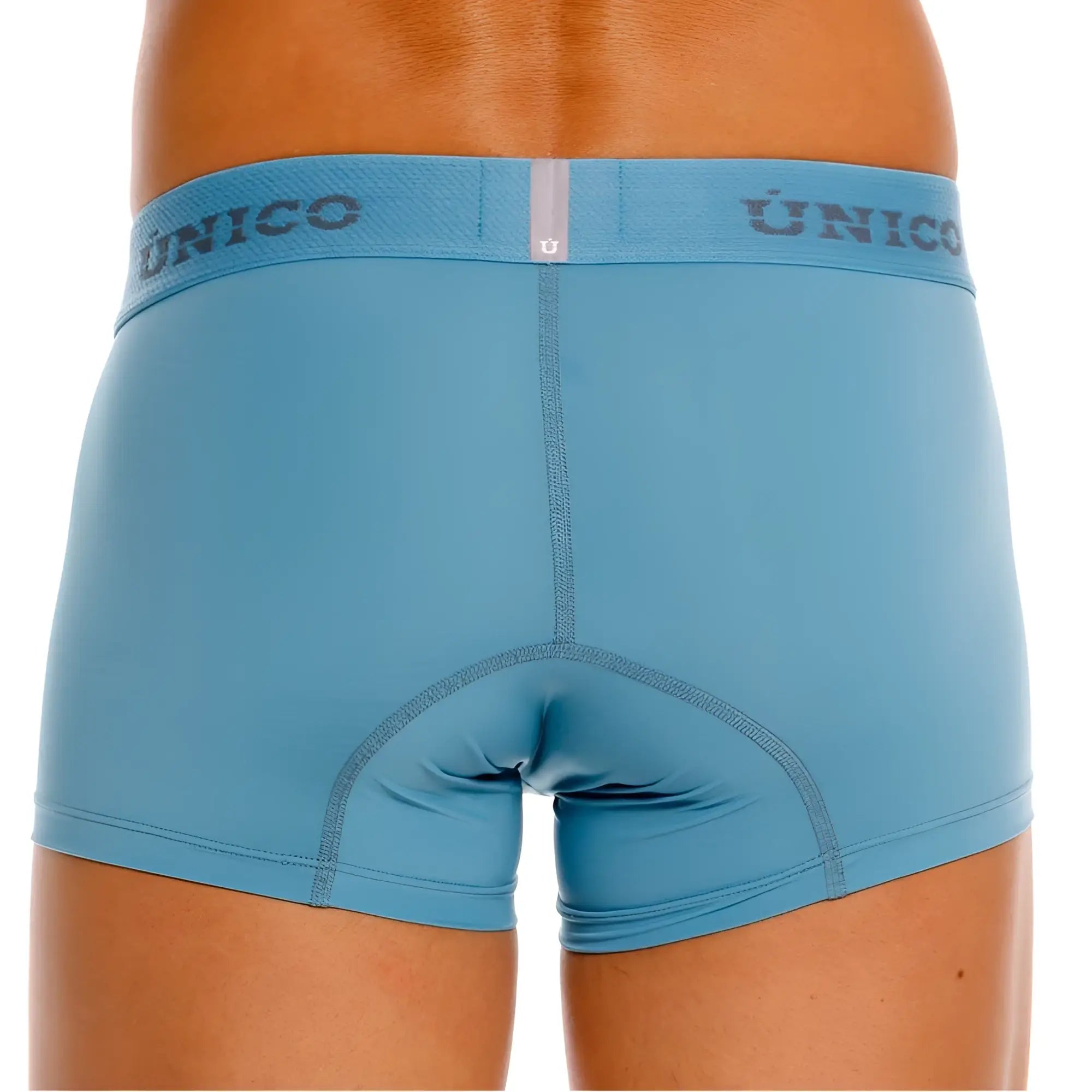 Light blue unico 26020100118 ventisca trunks with matching elastic waistband featuring dark gray unico lettering