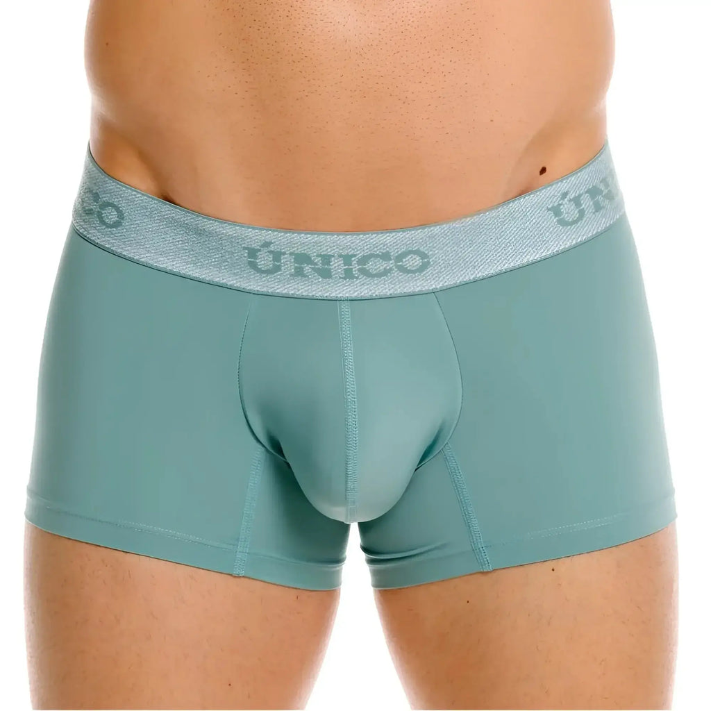 Front view of Unico Ceramic trunks in green, featuring a branded waistband.