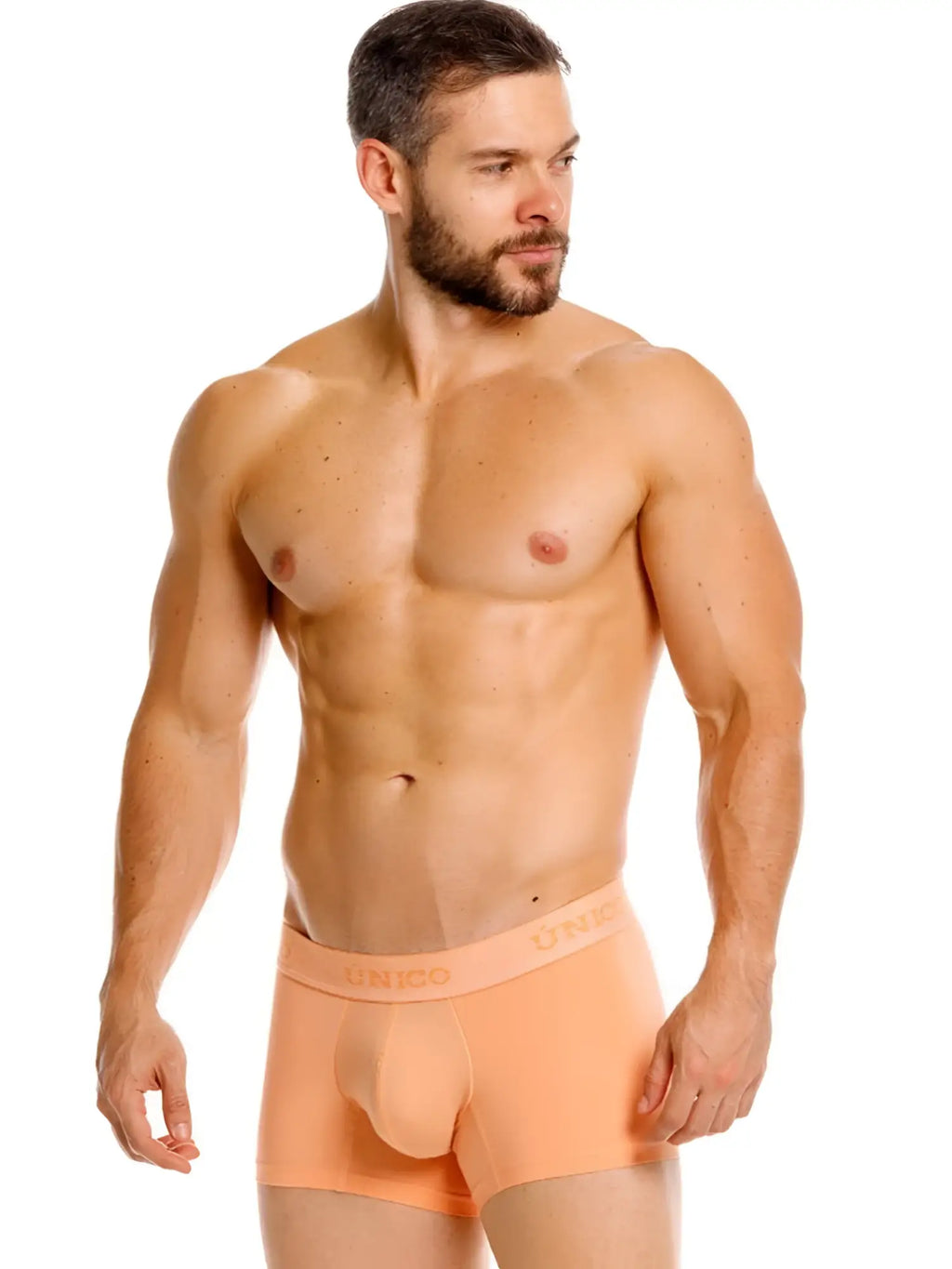 Front view of a model wearing Unico 26040100122 Classic Trunks in apricot.