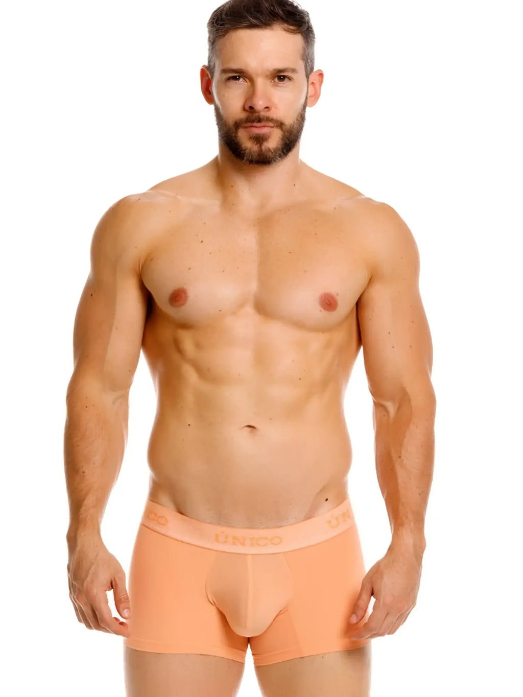 Front view of Unico Classic Trunks in apricot, worn by a model.