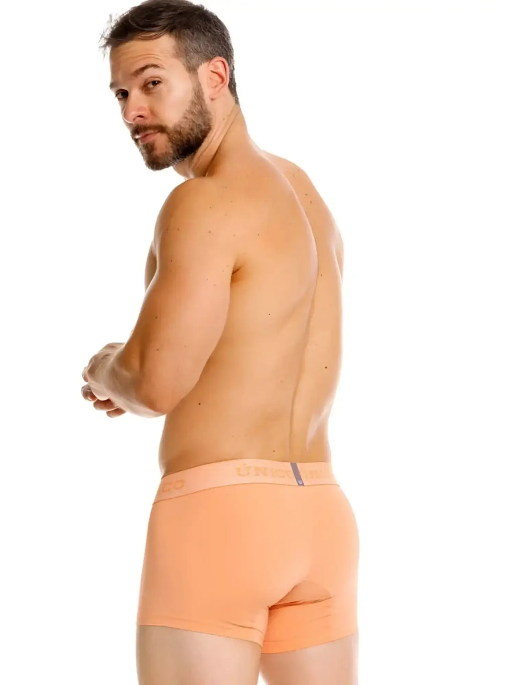 Unico 26040100122 Classic Trunks in Apricot. Back view lifestyle shot of man wearing trunks.