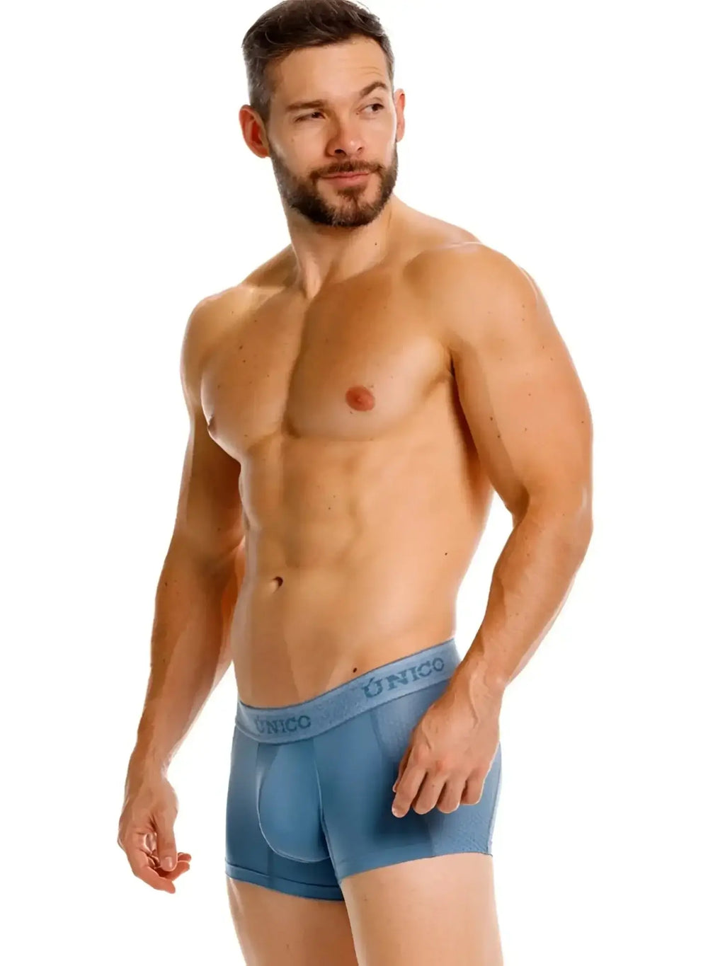 Unico Classic Trunks in blue, shown on a male model in a front-angle studio view.