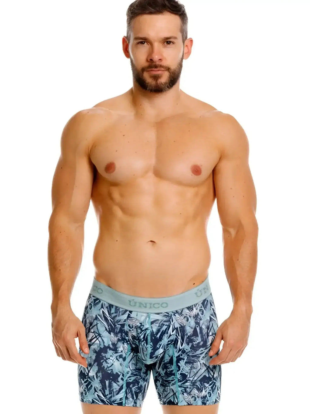 Front view of a model wearing Unico Tags Boxer Briefs in blue with a printed pattern.