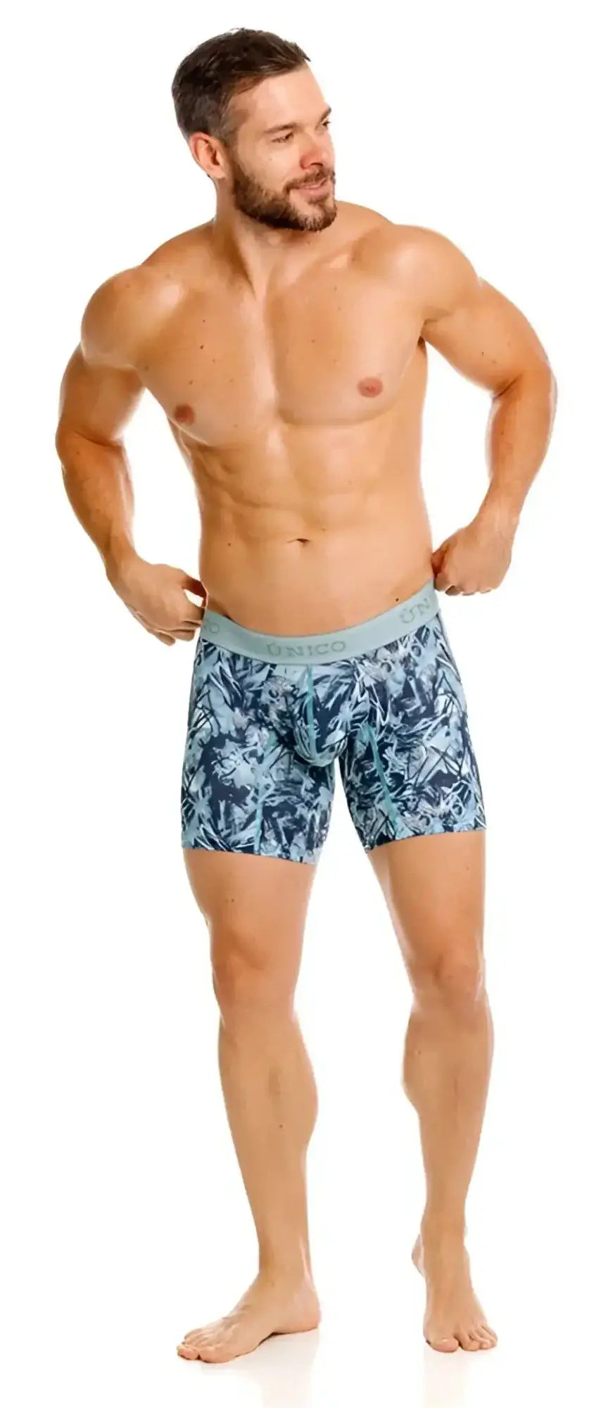 Unico Tags boxer briefs in blue: full-length studio shot of a model wearing the patterned underwear.