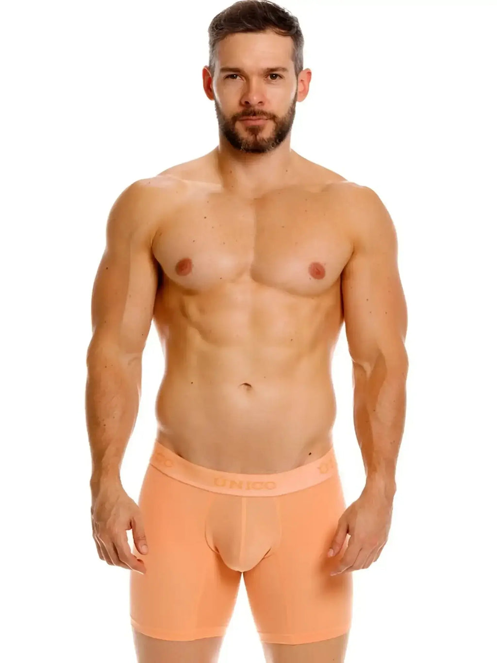 Front view of a model wearing Unico Classic Boxer Briefs in Apricot against a white background.