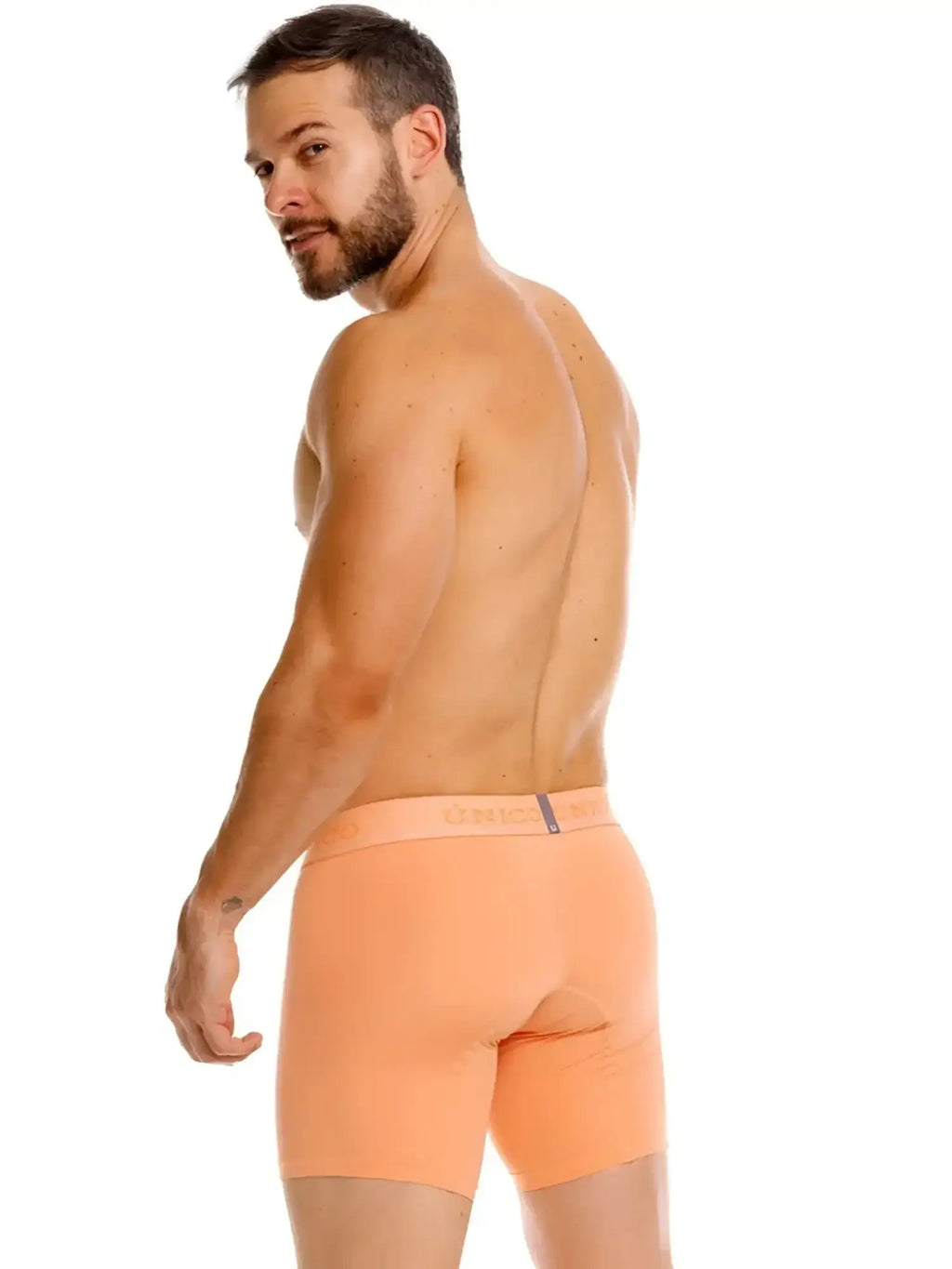 Unico Classic Boxer Briefs in apricot, rear view of a man wearing them against a white background.
