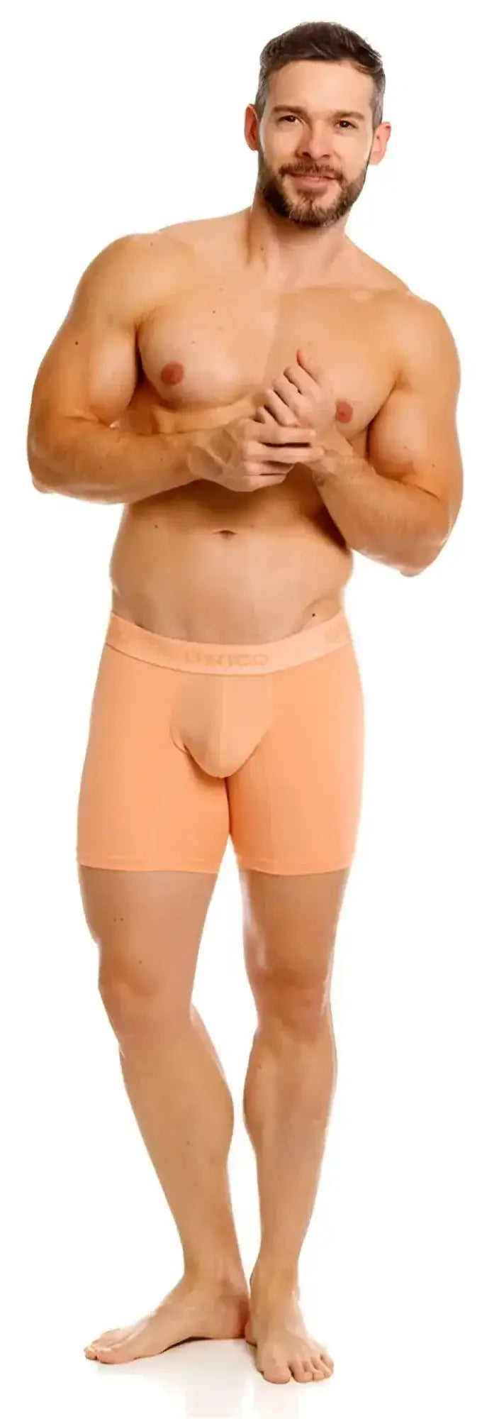 Model wearing Unico Classic Boxer Briefs in apricot, front view against a white background.