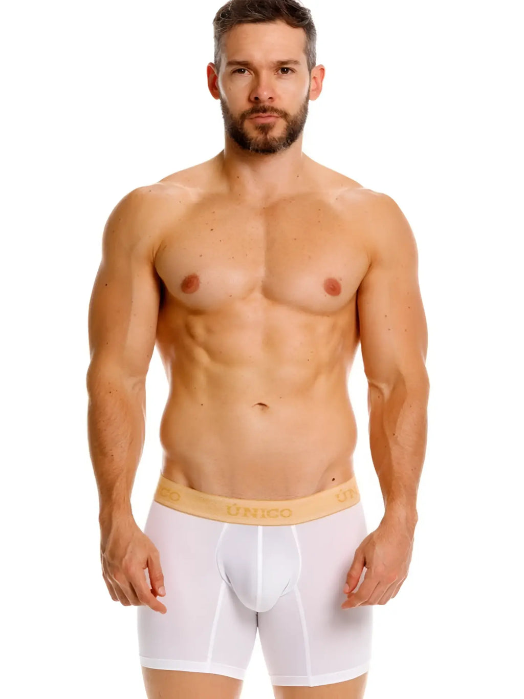 Front view of a model wearing white Unico Amber boxer briefs with a branded gold waistband.