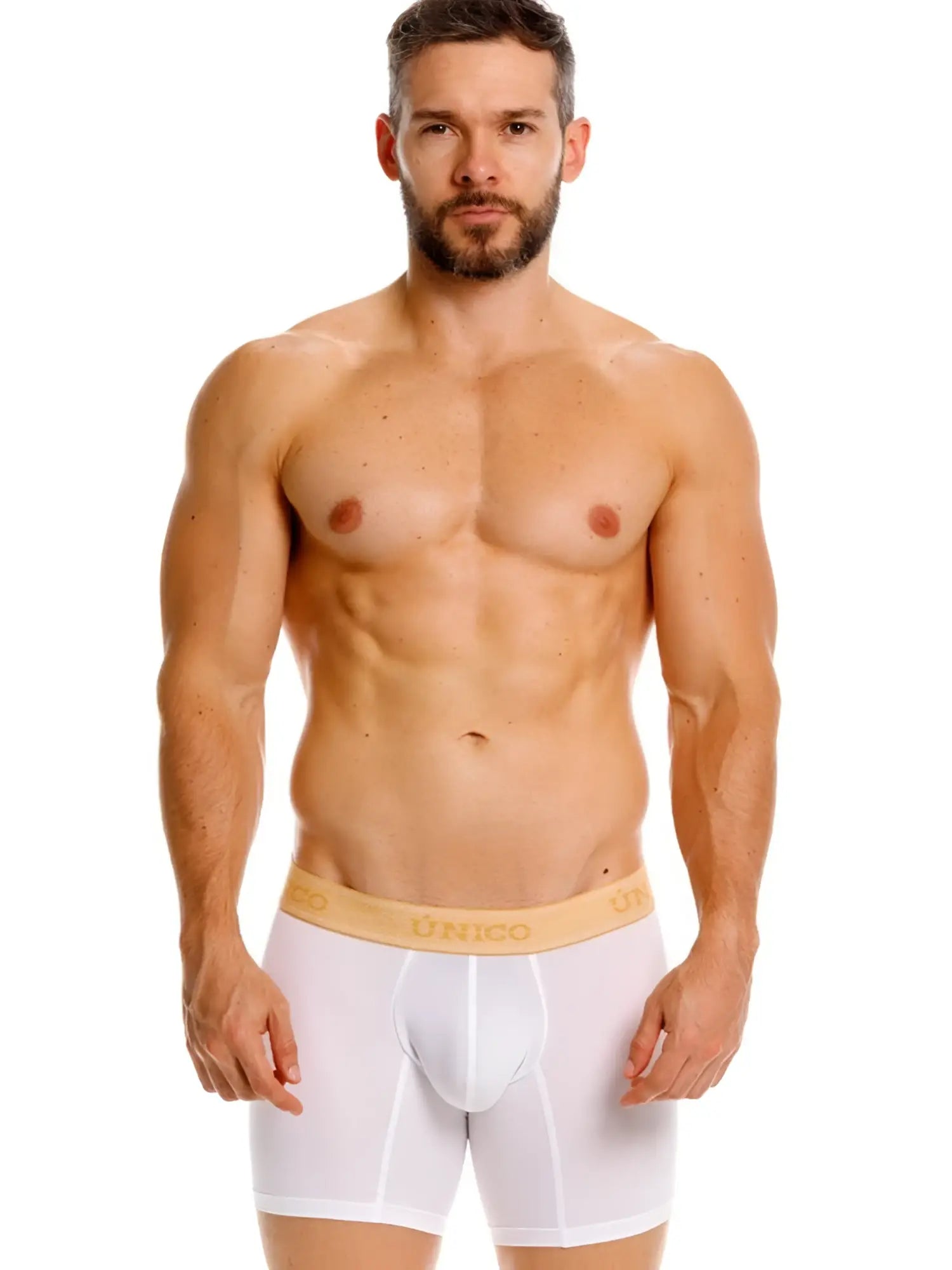 Front view of a model wearing white Unico Amber boxer briefs with a branded gold waistband.