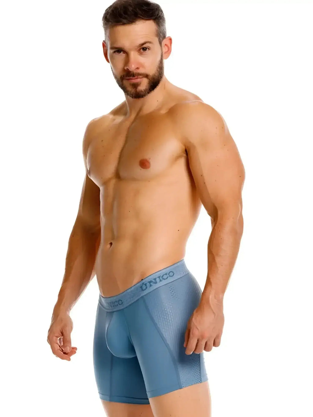 Unico 26040100227 Classic Boxer Briefs in blue. Lifestyle shot of a model wearing the boxers, side view.