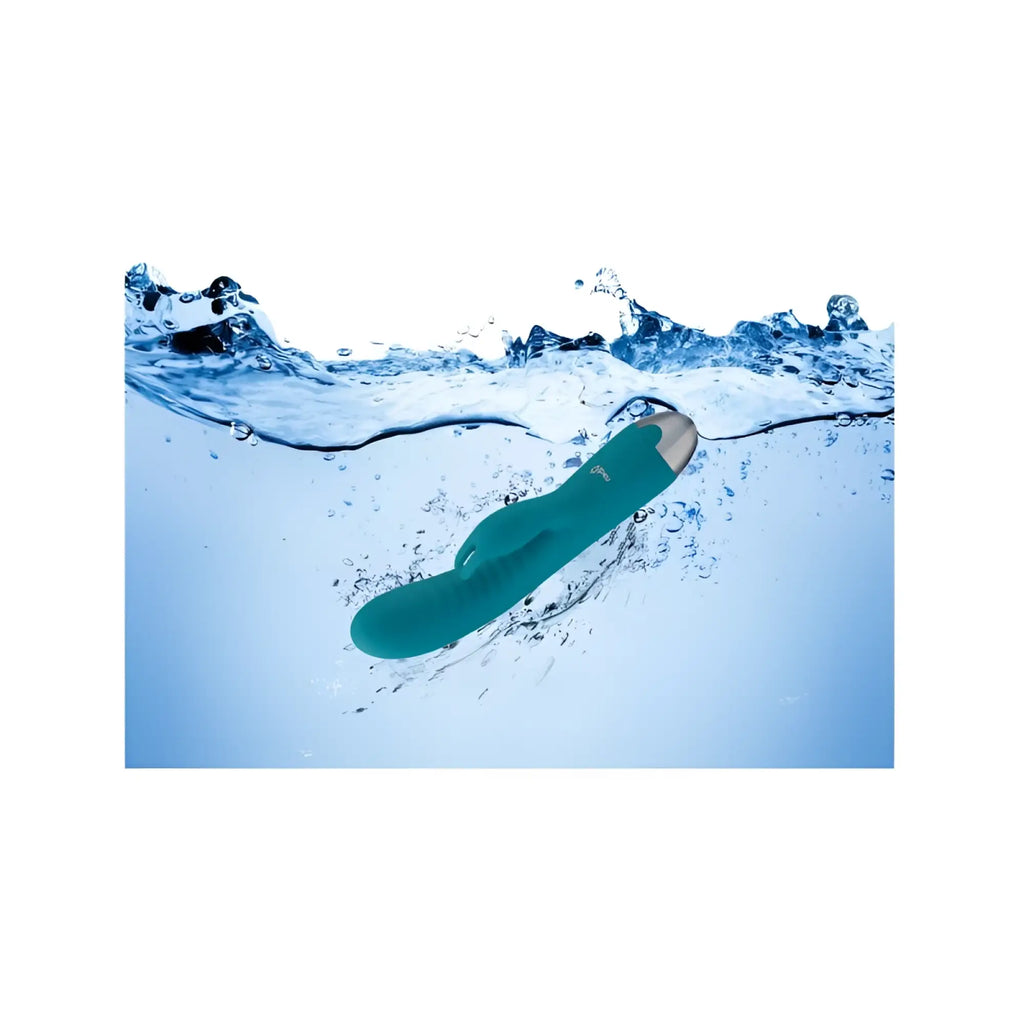 Teal silicone rabbit vibe with silver tip partially submerged in water from viben alluring come hither ocean collection