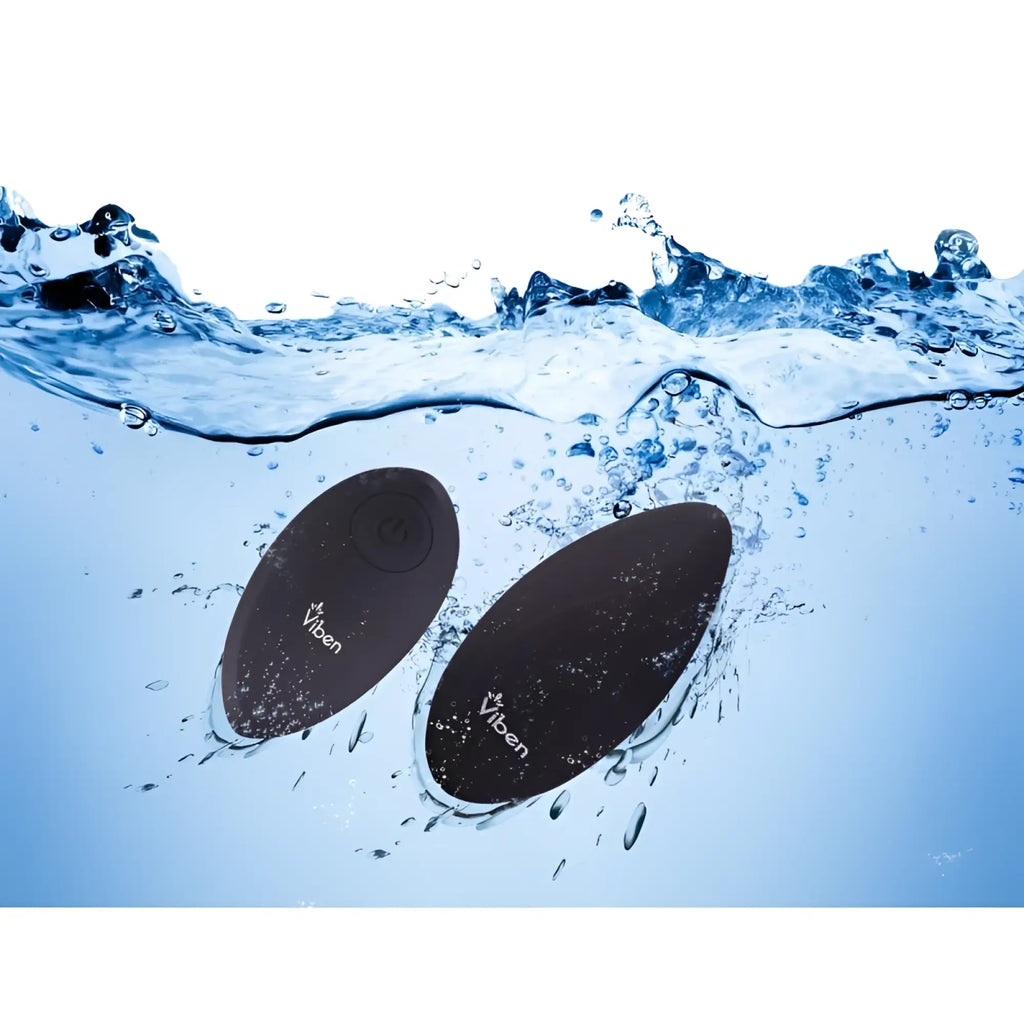 Black oval-shaped waterproof viben vibe floating in water from viben racy multi function panty vibe with remote