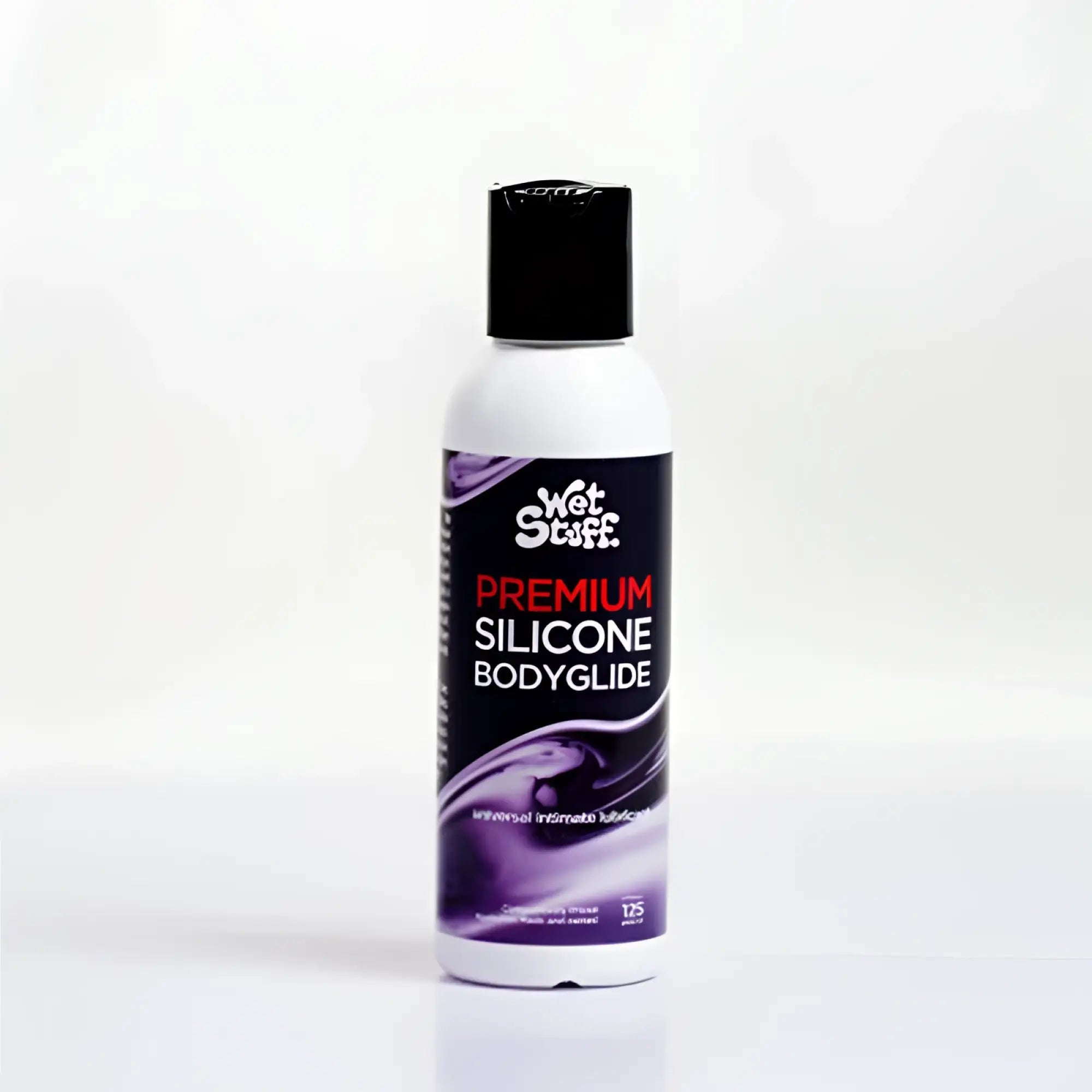 A white bottle with black cap and purple label of Wet Stuff premium silicone bodyglide disc top 125g product
