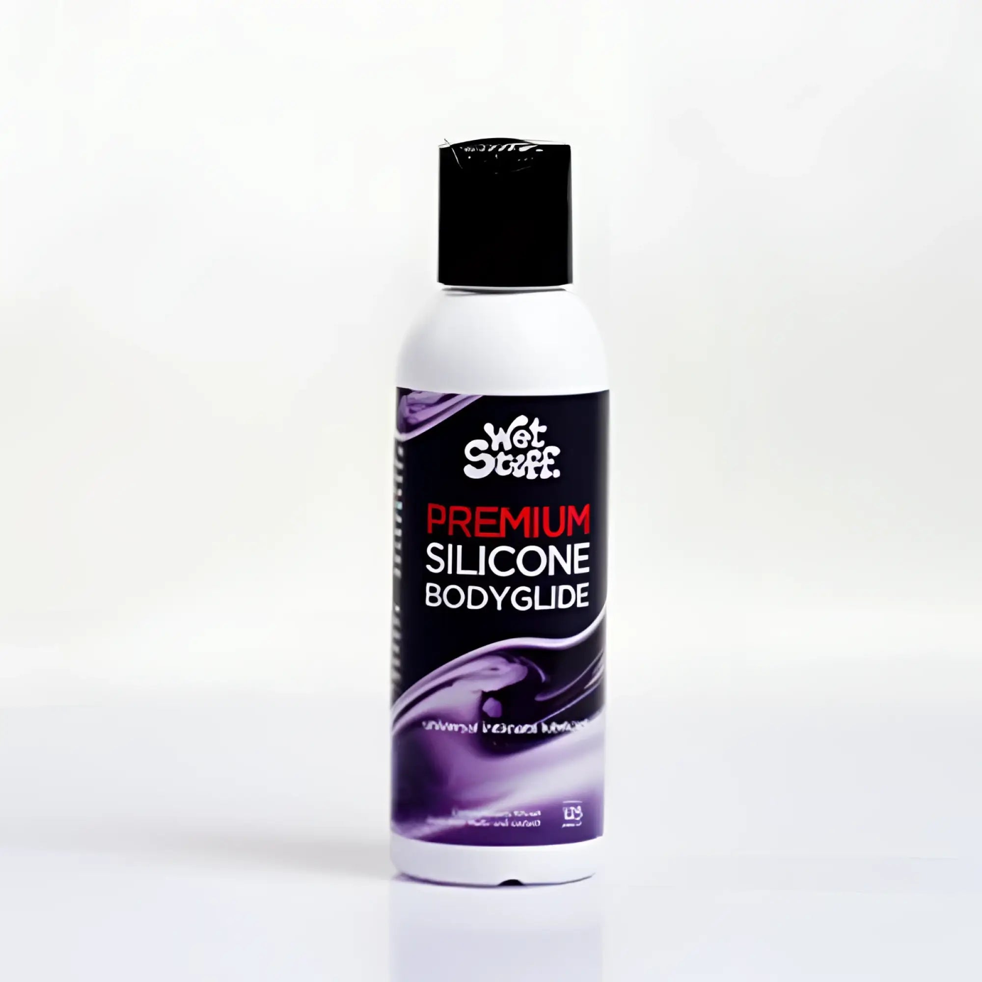 A white bottle with black cap and purple label of Wet Stuff premium silicone bodyglide disc top 50g