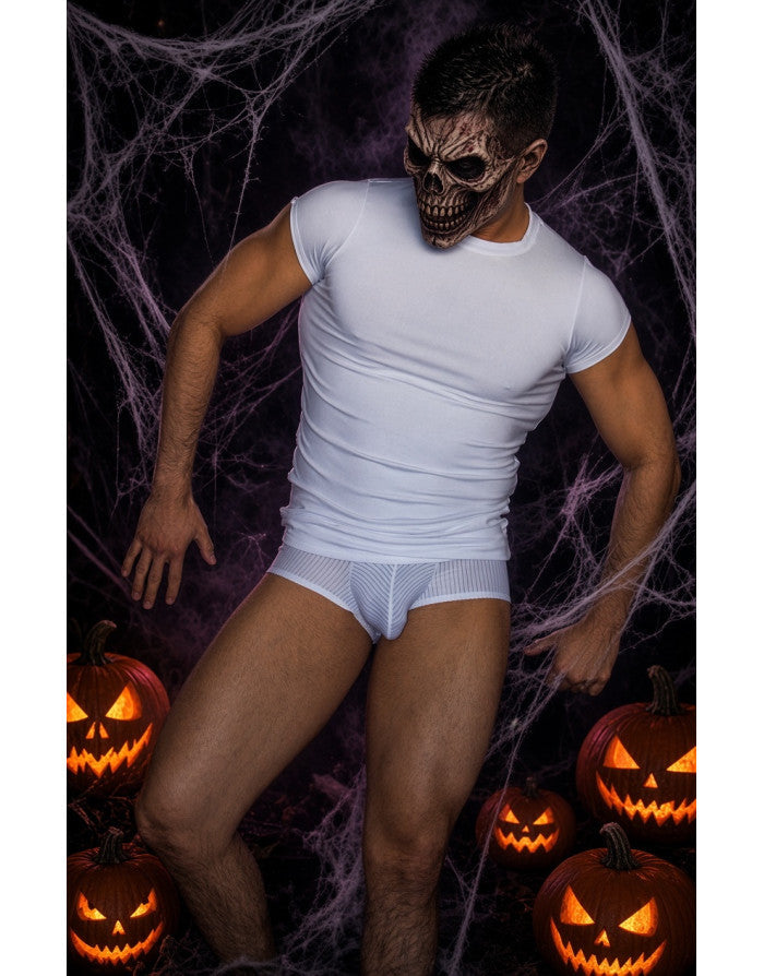 Model wearing a white spandex t-shirt by Arroyman posing with a skull mask in a Halloween-themed setting with pumpkins and cobwebs