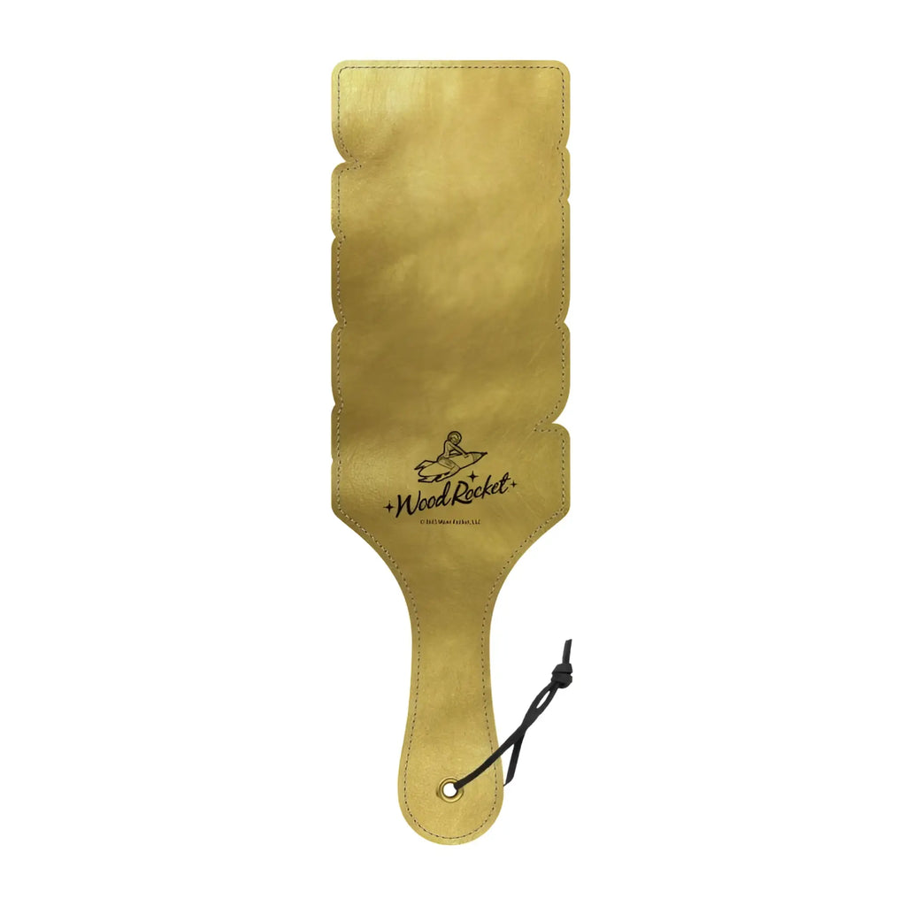Wood rocket paddle daddy gold-colored leather paddle with scalloped edge and black cord attached to handle