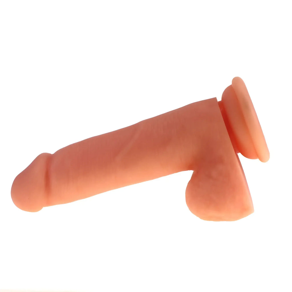 Peach-colored silicone dildo with rounded head flared base thick realistic design and balls from X-MEN Flesh series