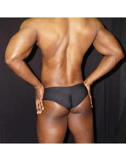 Black boxer underwear by Arroyman featuring a snug fit and smooth fabric shown on a model from the back.