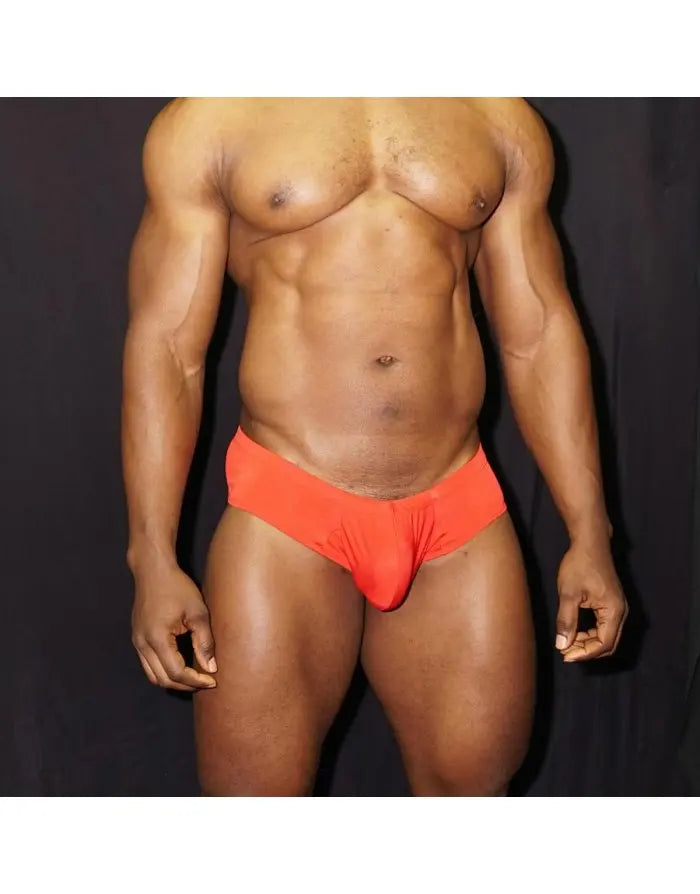 Red boxer underwear by Arroyman featuring a snug fit and soft material shown on a model against a dark background.