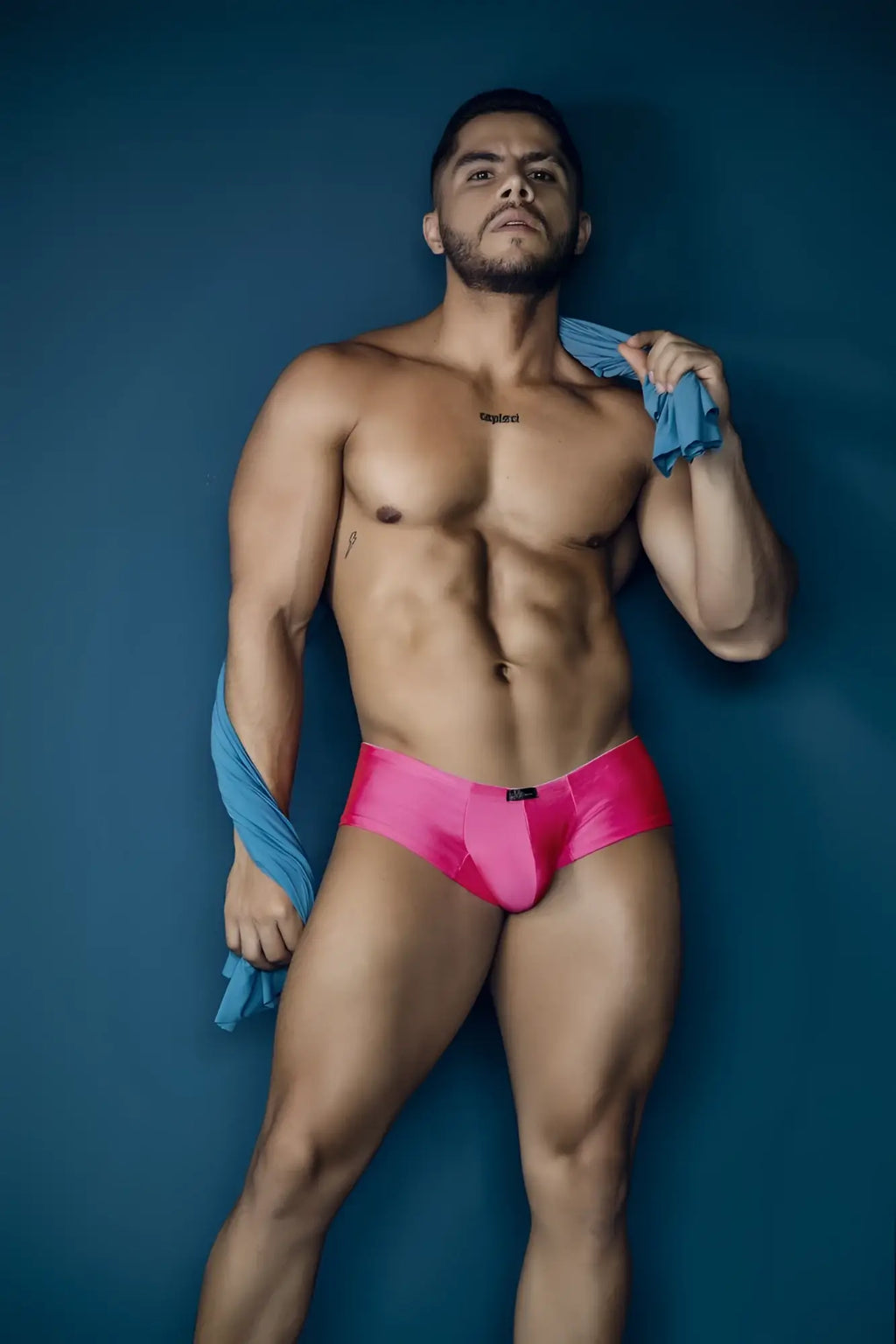 Vibrant fuchsia microfiber satin briefs with a sleek form-fitting design and black brand tag at the waistband