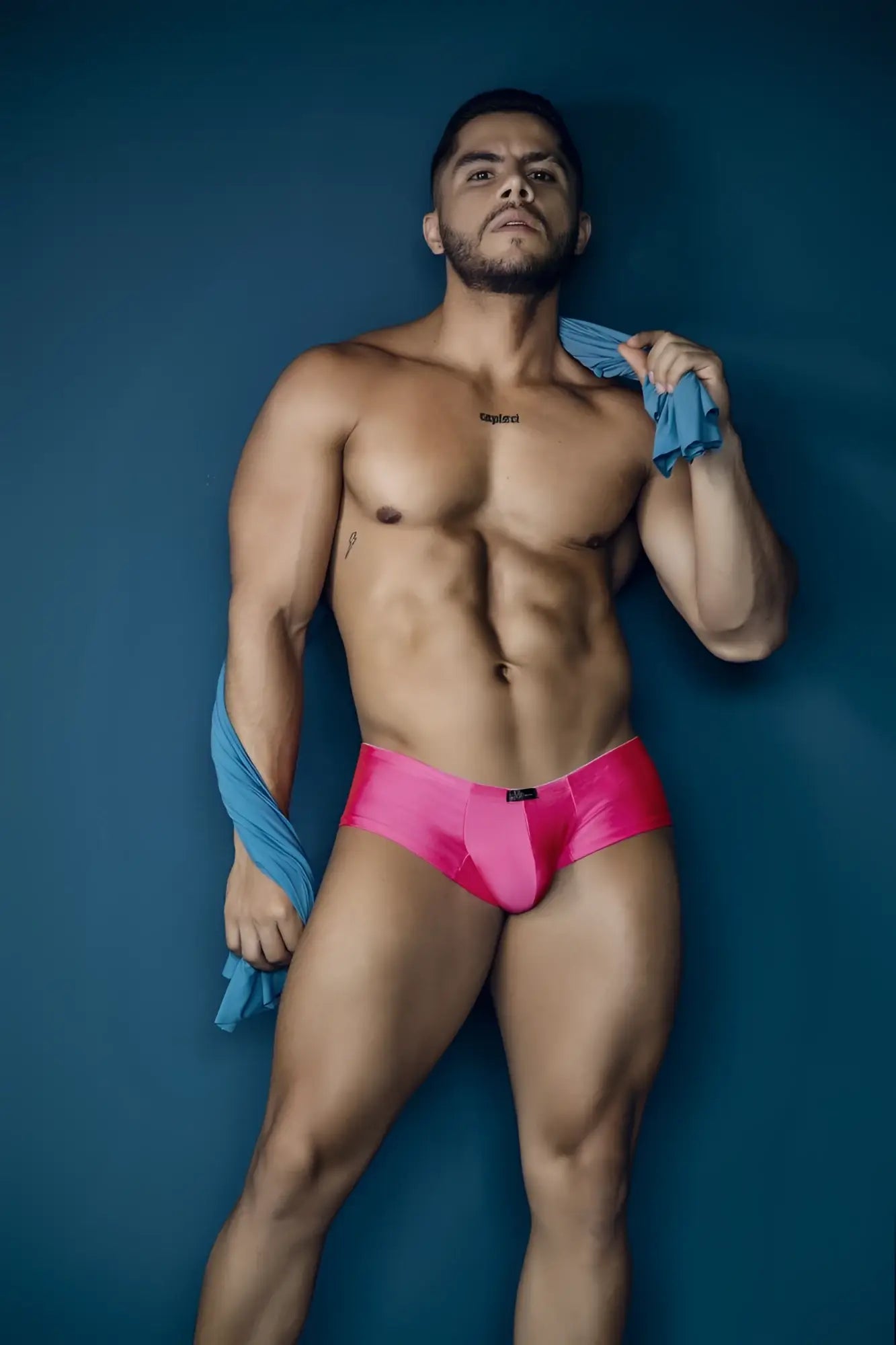 Vibrant fuchsia microfiber satin briefs with a sleek form-fitting design and black brand tag at the waistband