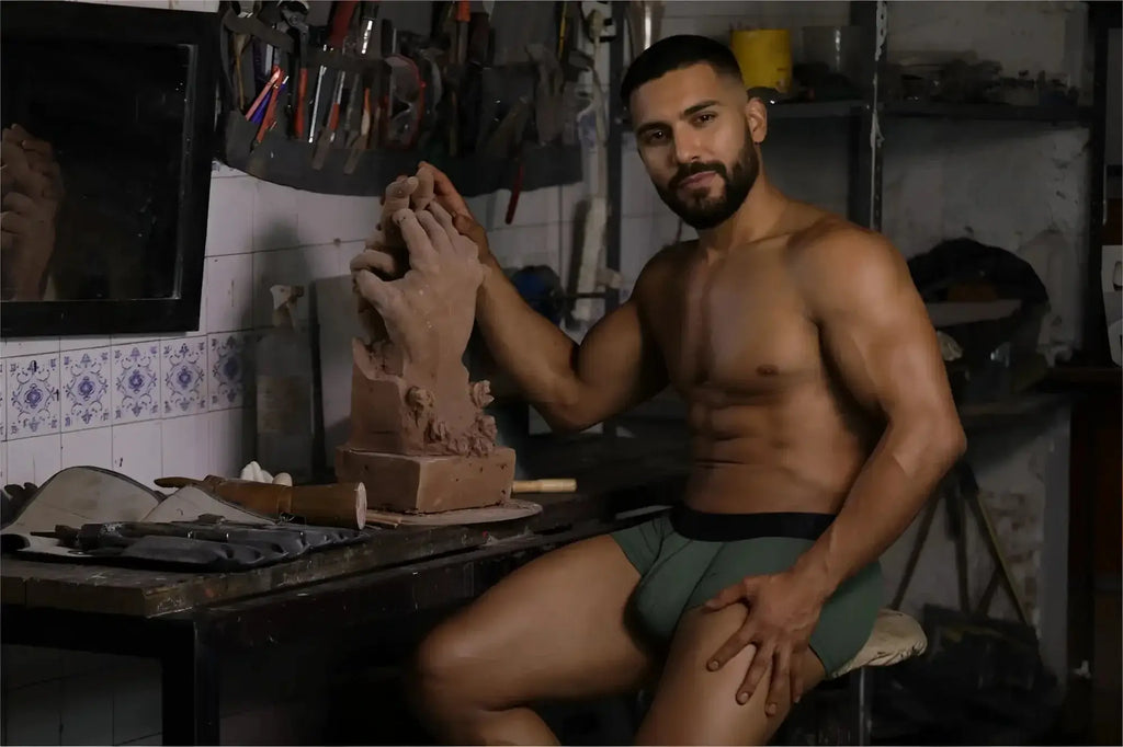 Lifestyle shot of a man wearing Xtremen 91252 Microfiber Mesh Trunks in Military Green while working with clay.